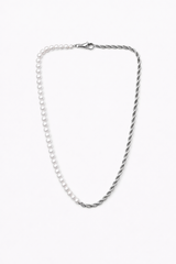 Collar Ira plateado mitad cordón y mitad perlas sobre fondo claro