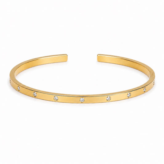 Brazalete Destello dorado abierto de banda fina con detalles brillantes redondos