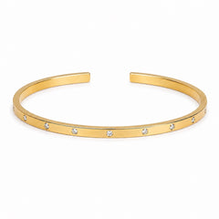 Brazalete Destello dorado abierto de banda fina con detalles brillantes redondos